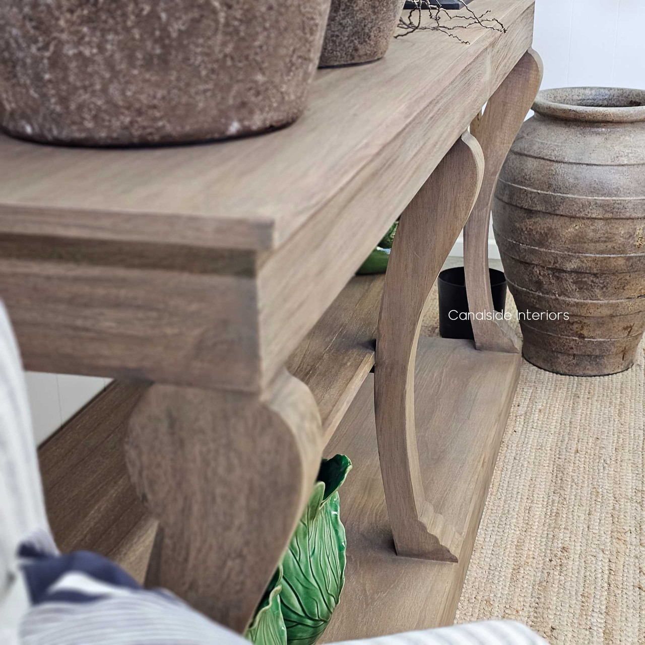 Console layered with sculptural vessels and dried foliage, for a textural, curated look.