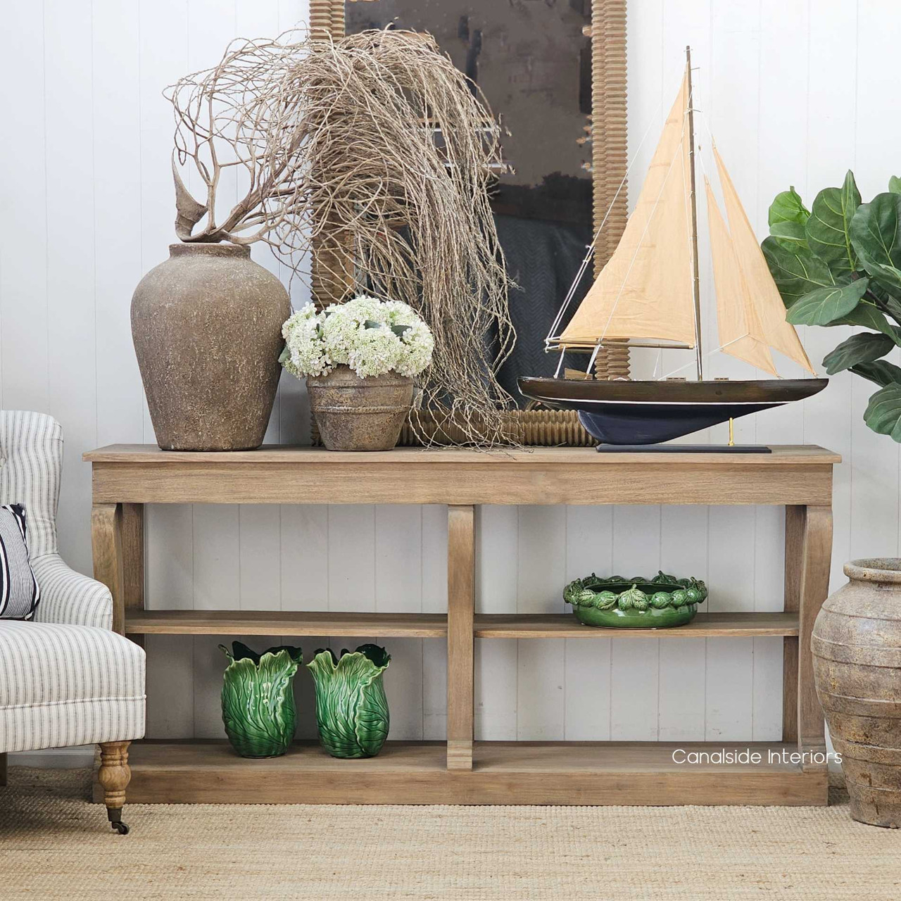 Front view of the Bramwell Console Table, showing its sculptural legs and weathered oak finish.