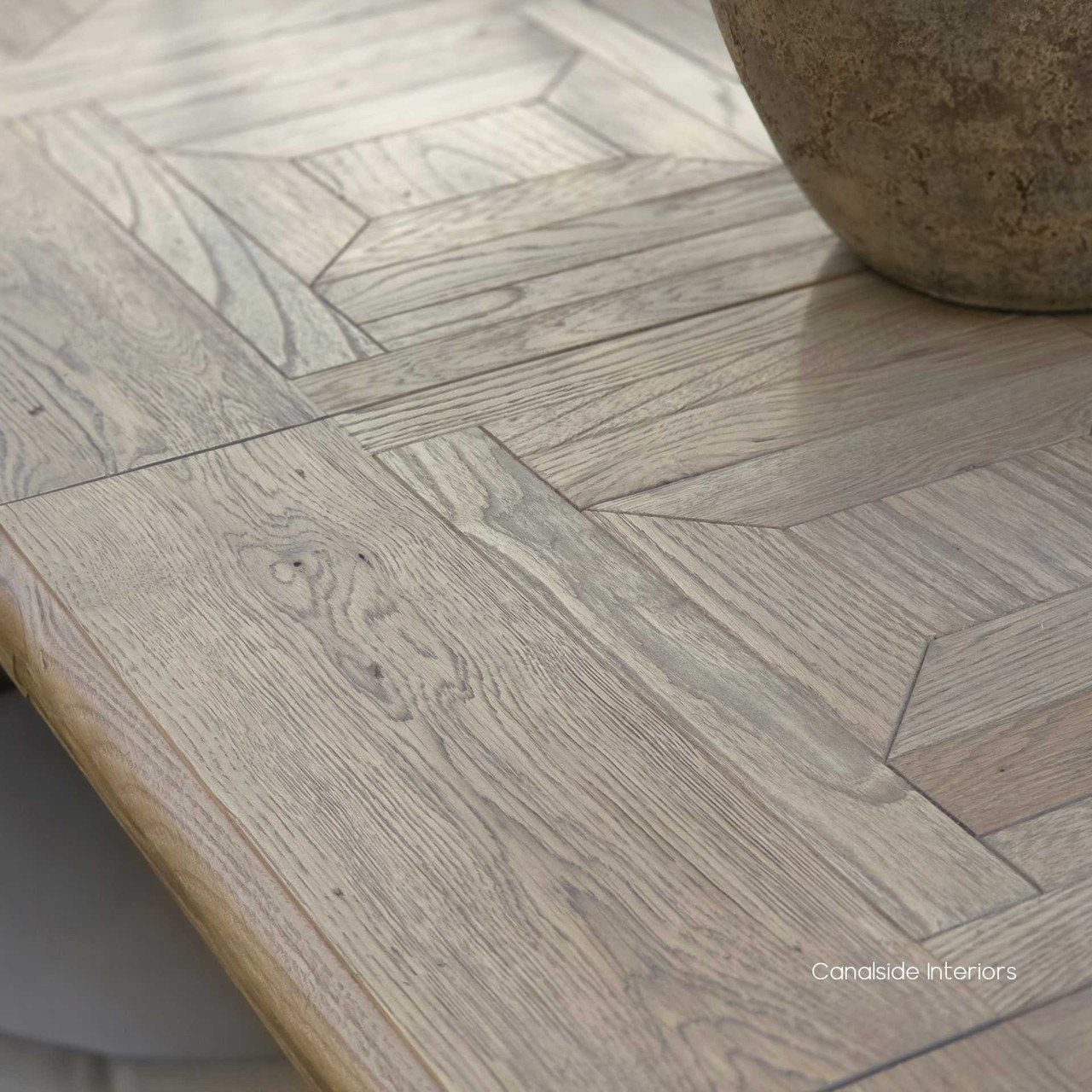 Parquetry tabletop detail showing hand-finished craftsmanship on the Chesterton dining table.