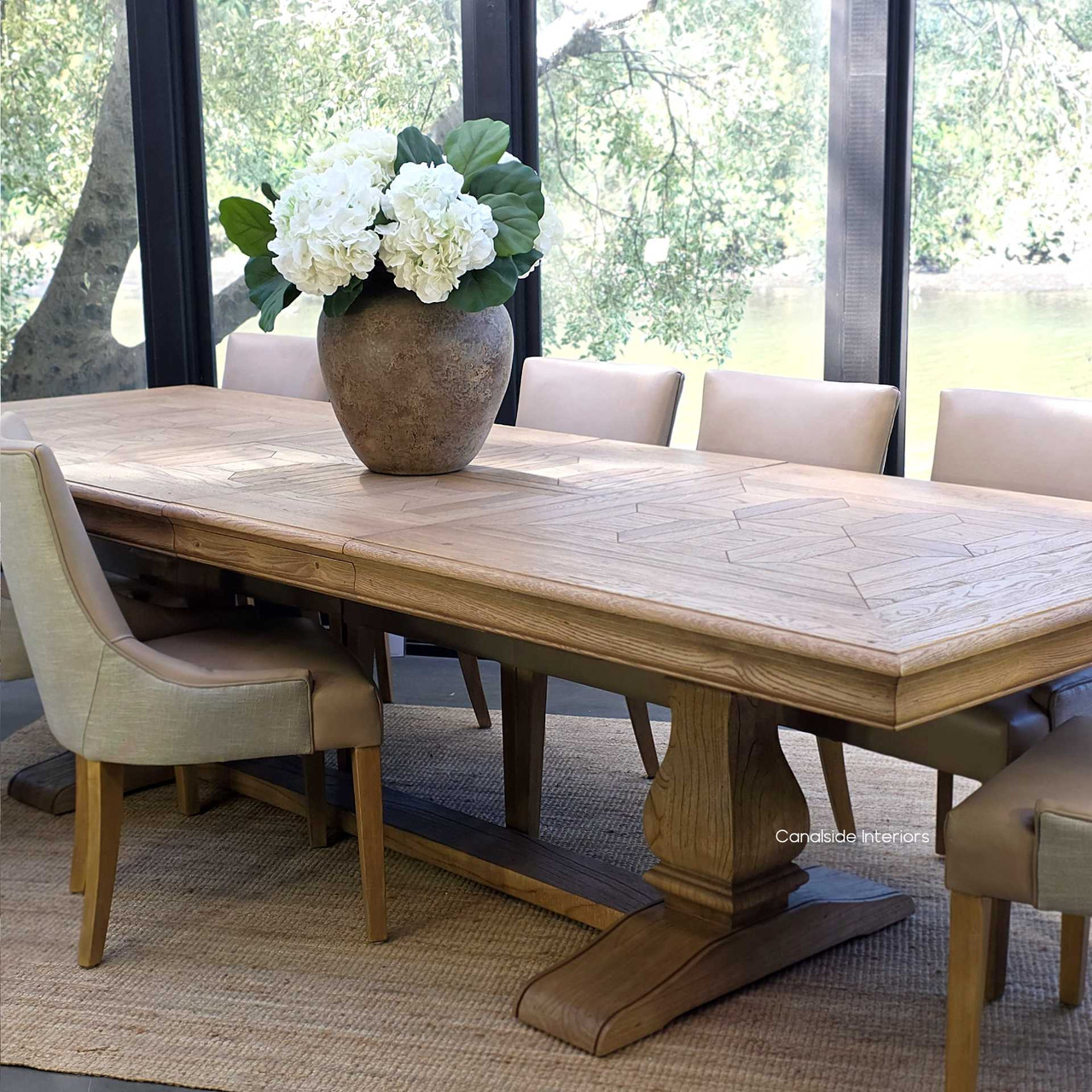 Chesterton Double Extension dining table paired with luxury leather upholstered chairs.