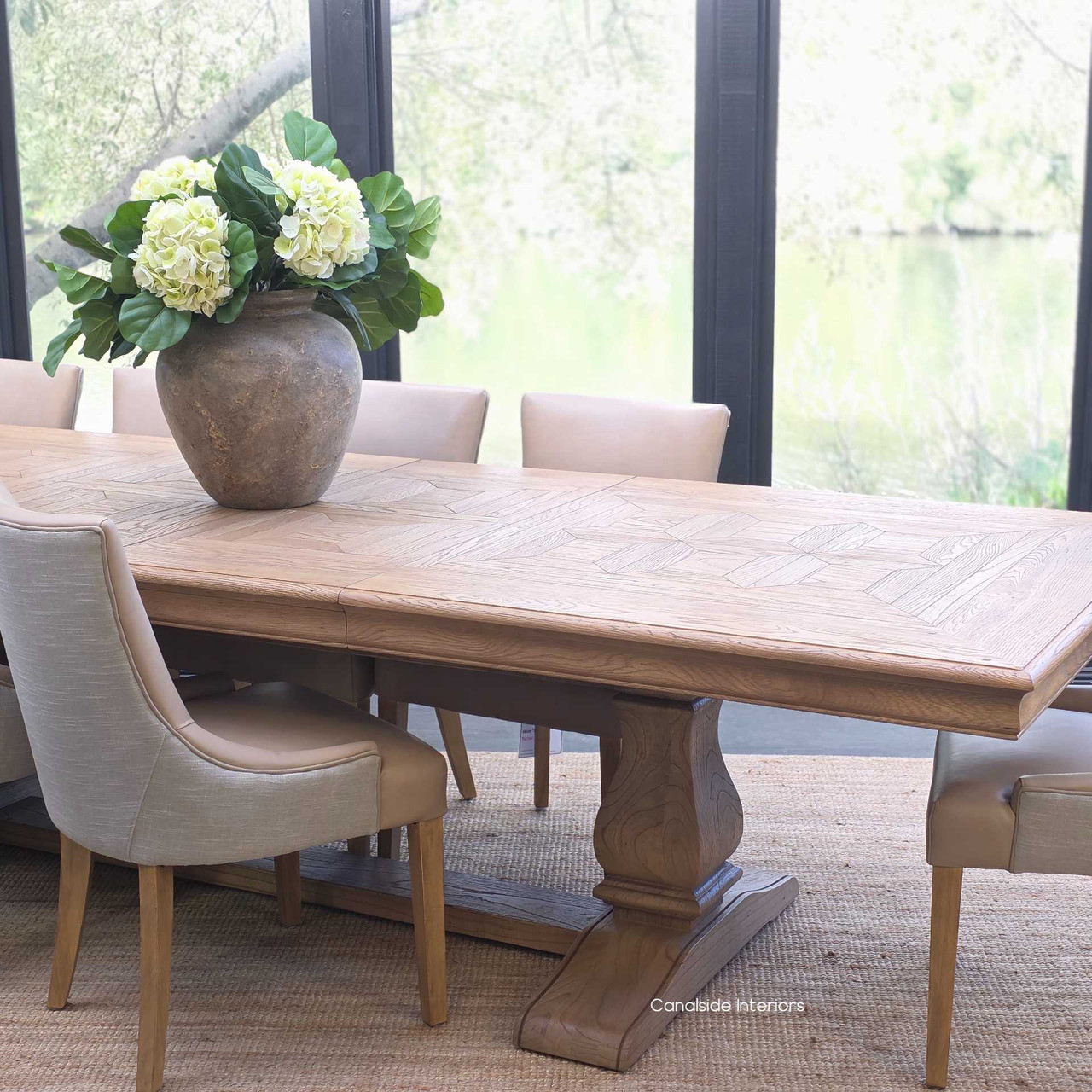 Chesterton oak dining table in a spacious dining room with modern décor.