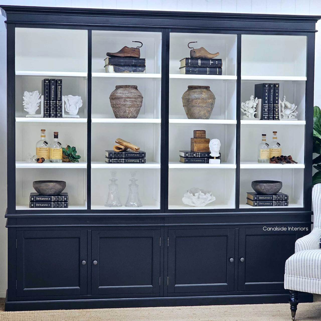 Angled view highlighting the layered white shelves set within the bold black frame.