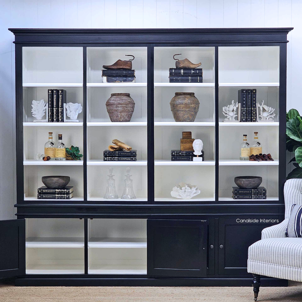 Cabinet doors open, revealing concealed lower storage beneath the open shelving.