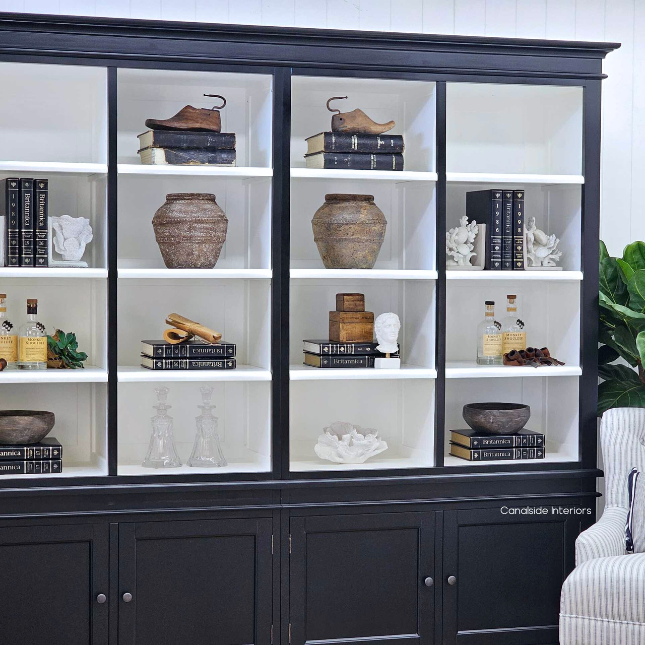 Angled perspective from the left side, showing shelf depth and refined black painted finish.