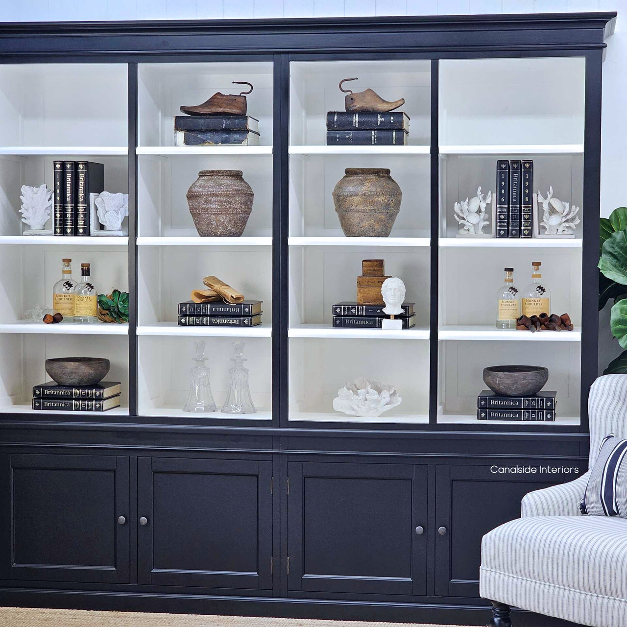 White shelves styled with books, ceramics and glassware for a refined coastal look.
