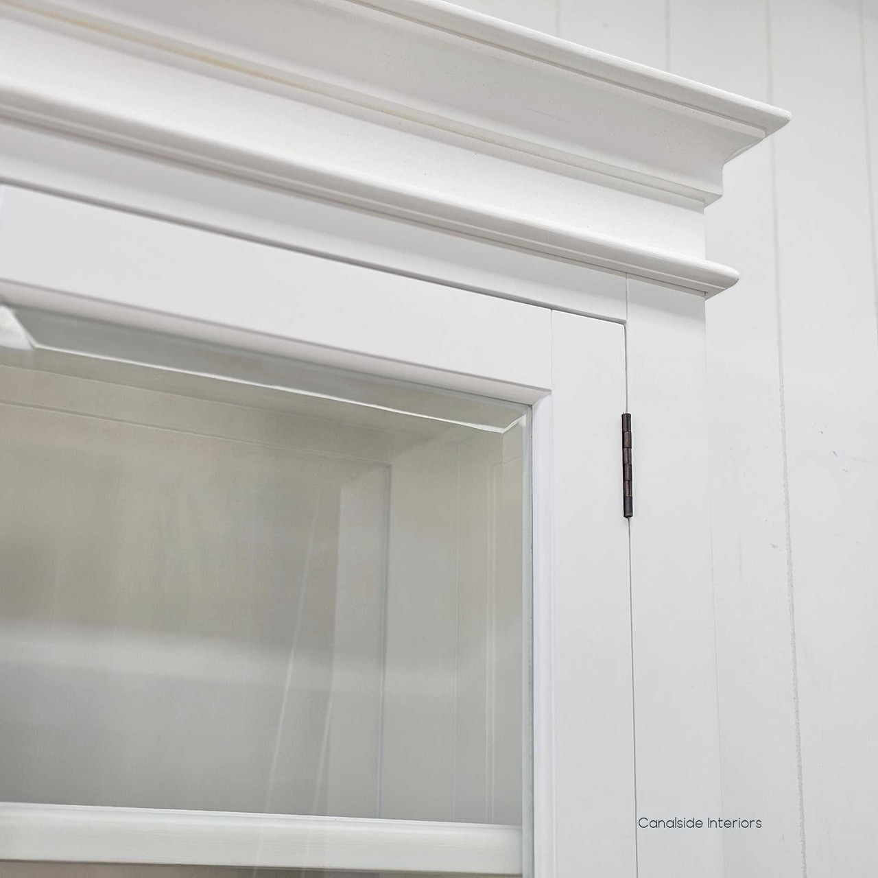 Detail view of the top cornice moulding and bevelled glass to highlight traditional design influence.
