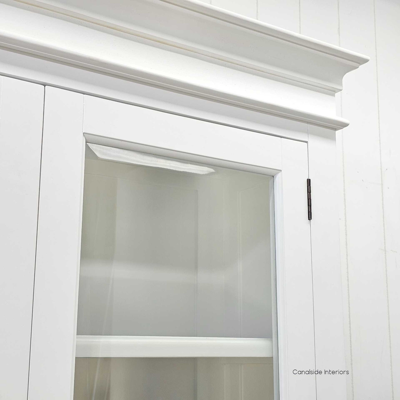 Zoomed-in shot of the glass door hinges, bevelled glass and frame joinery, showcasing craftsmanship.