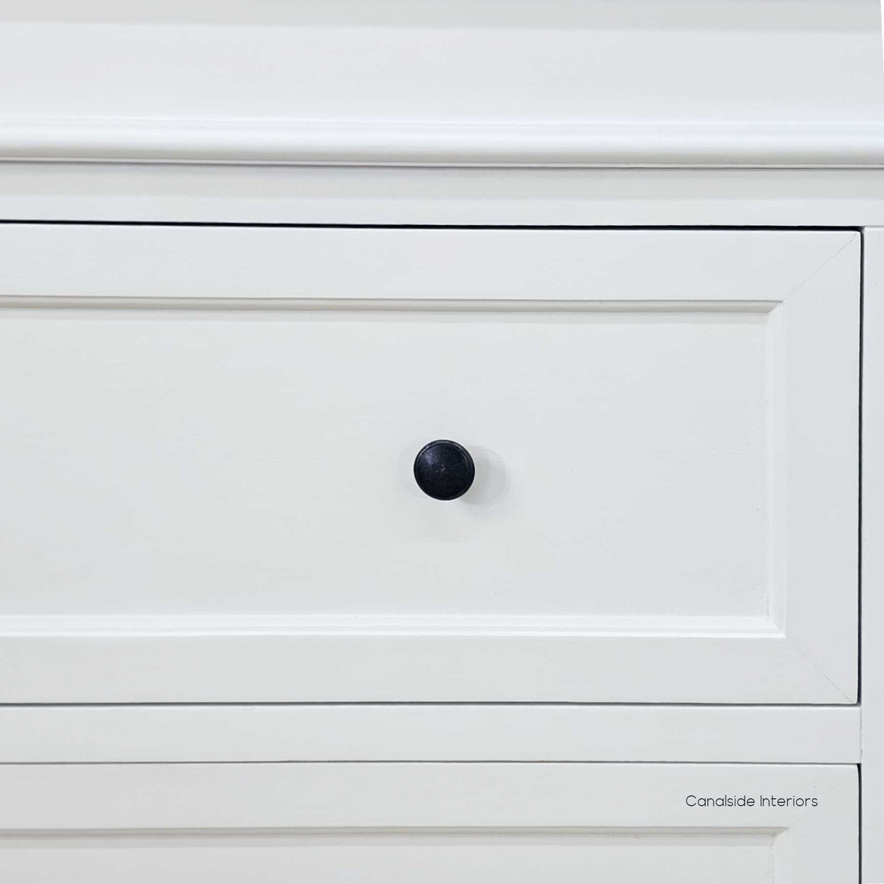 Close-up of the shaker-style drawer fronts with brass knobs for a clean, timeless contrast.