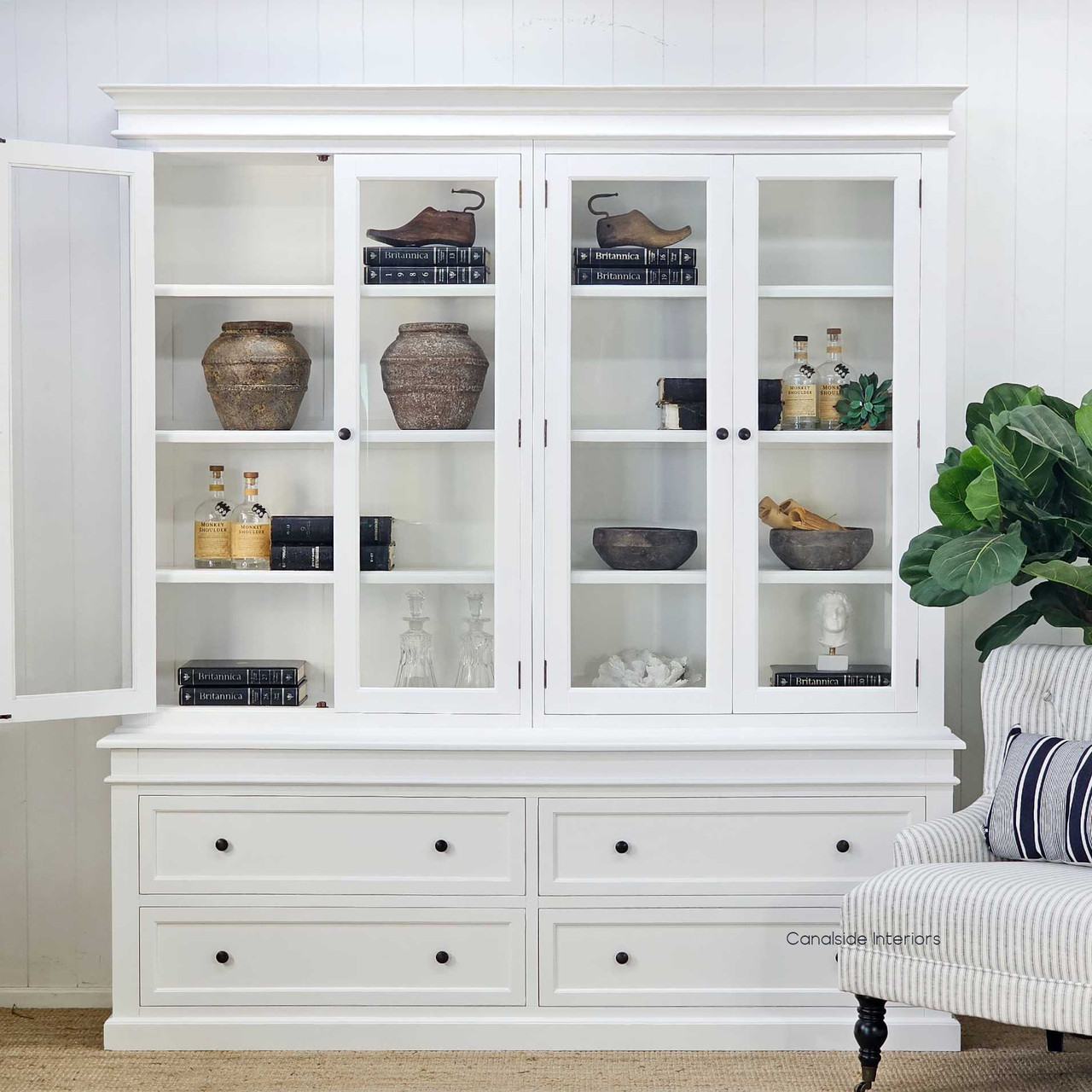 White shelves with doors ajar and arranged with warm timber accents for a country-inspired setting.