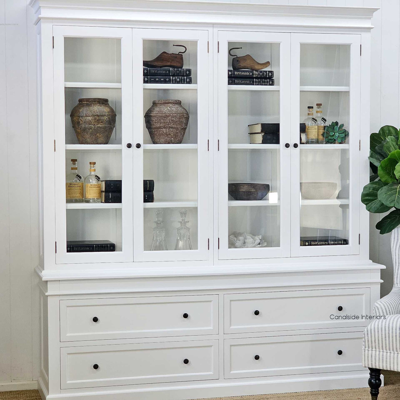Angled left-side view of the display wall unit, capturing the depth and profile of the drawers and hutch.

