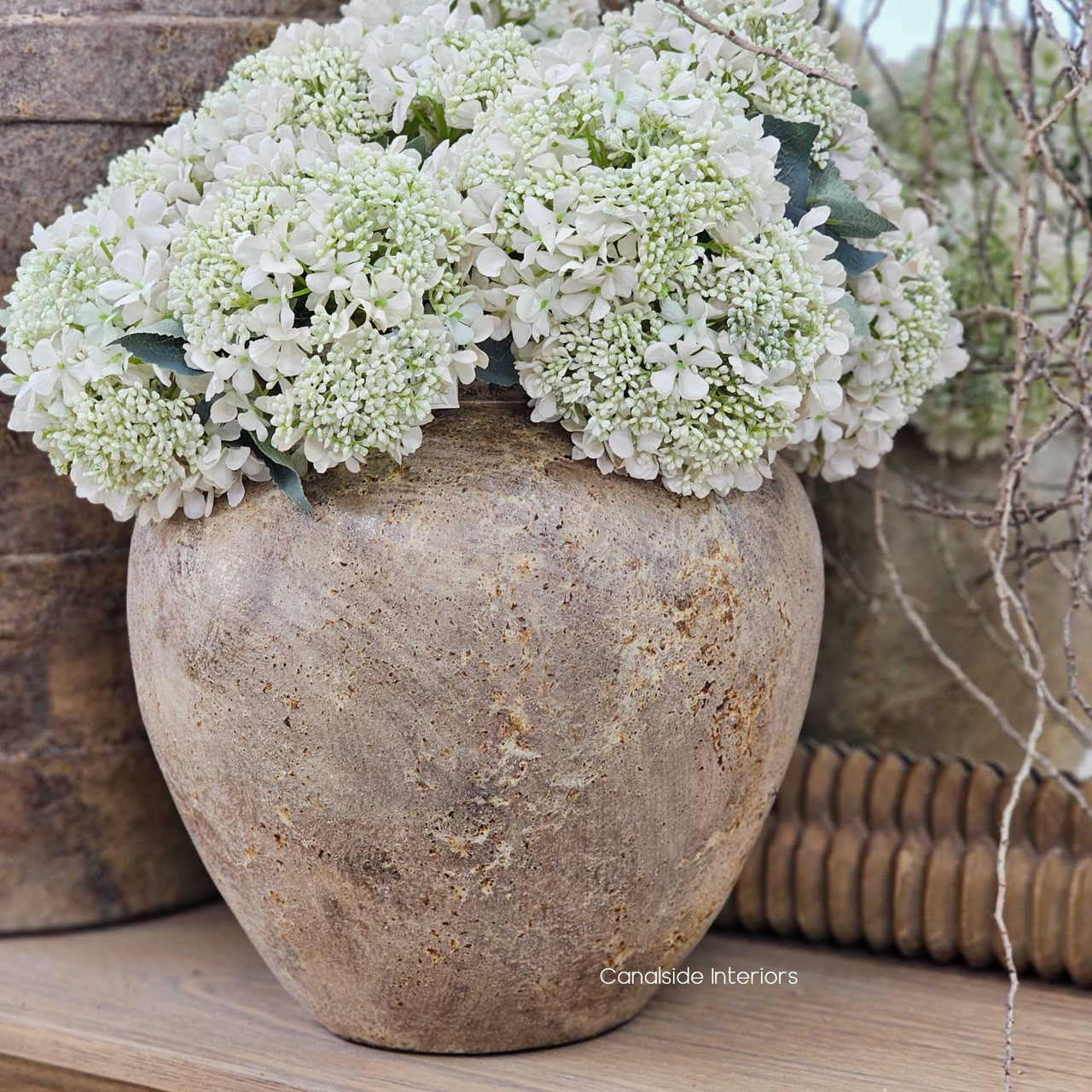 Close-up of the Noema Pot Vessel's weathered terracotta surface, showcasing its raw clay texture and earthy patina.