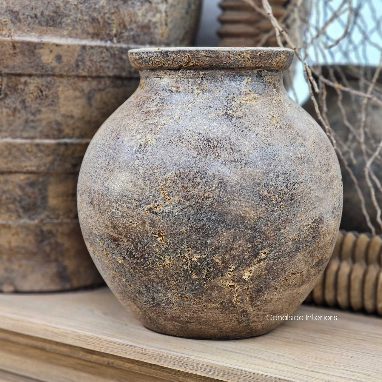 Front view of the Ismara Clay Pot Vessel, highlighting its sculptural round shape and natural clay patina.
