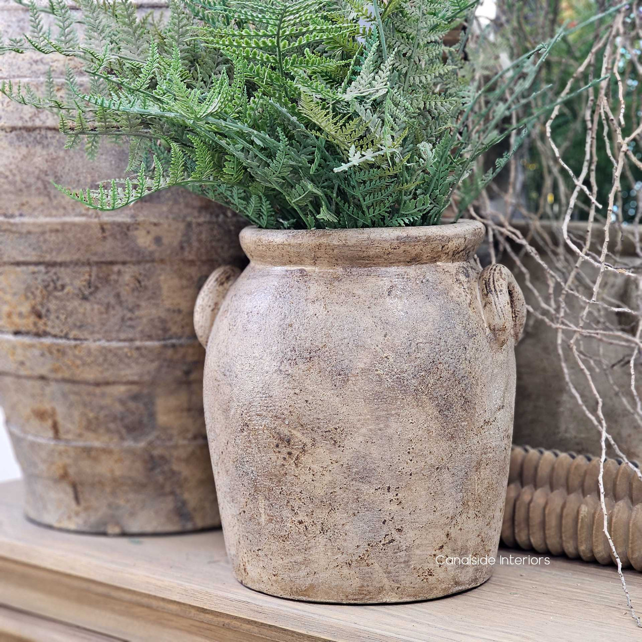 Side angle of the Sekar vessel, highlighting the sculptural looped handles and weathered surface.