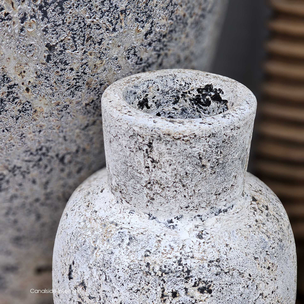 Detail shot of the vessel rim, showing the raw, porous clay edge and artisan-crafted patina.