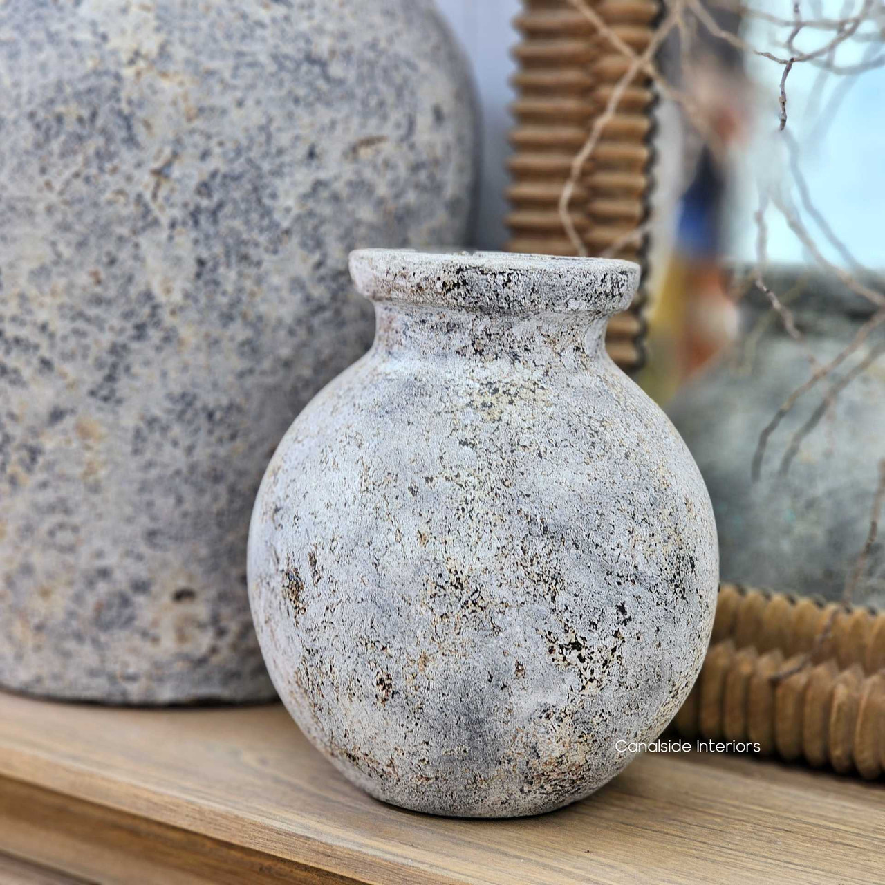 Focus on the pot’s sculptural silhouette, capturing the fullness of the belly and tapered neck.