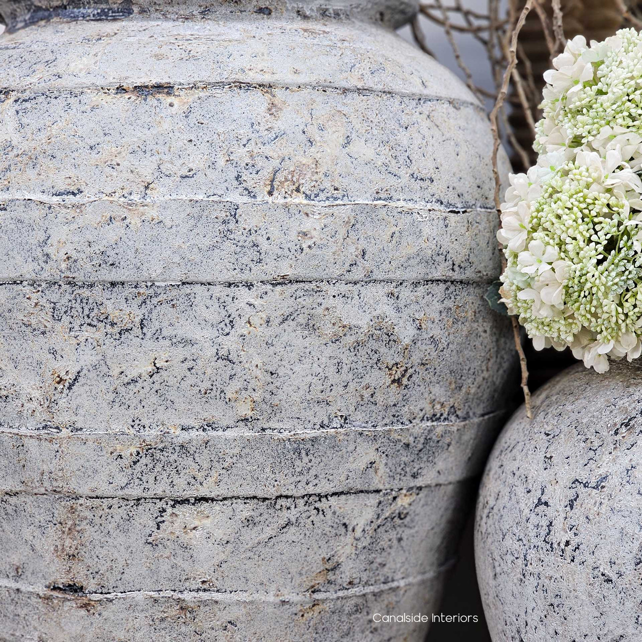 Close-up of the Ravena Terracotta Pot Planter Vessel’s horizontal ridges, showcasing the layered stonewash texture and artisanal detailing.