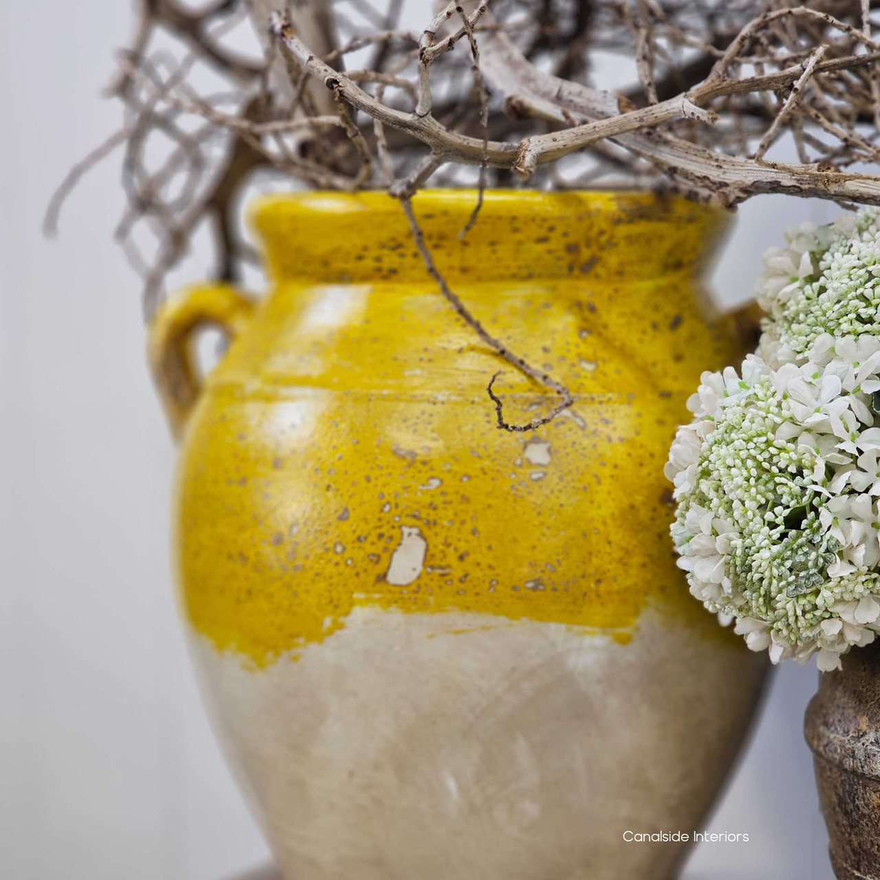 Side angle showing the confit pot’s classic silhouette, featuring its rounded form, short neck, and rustic footed base.