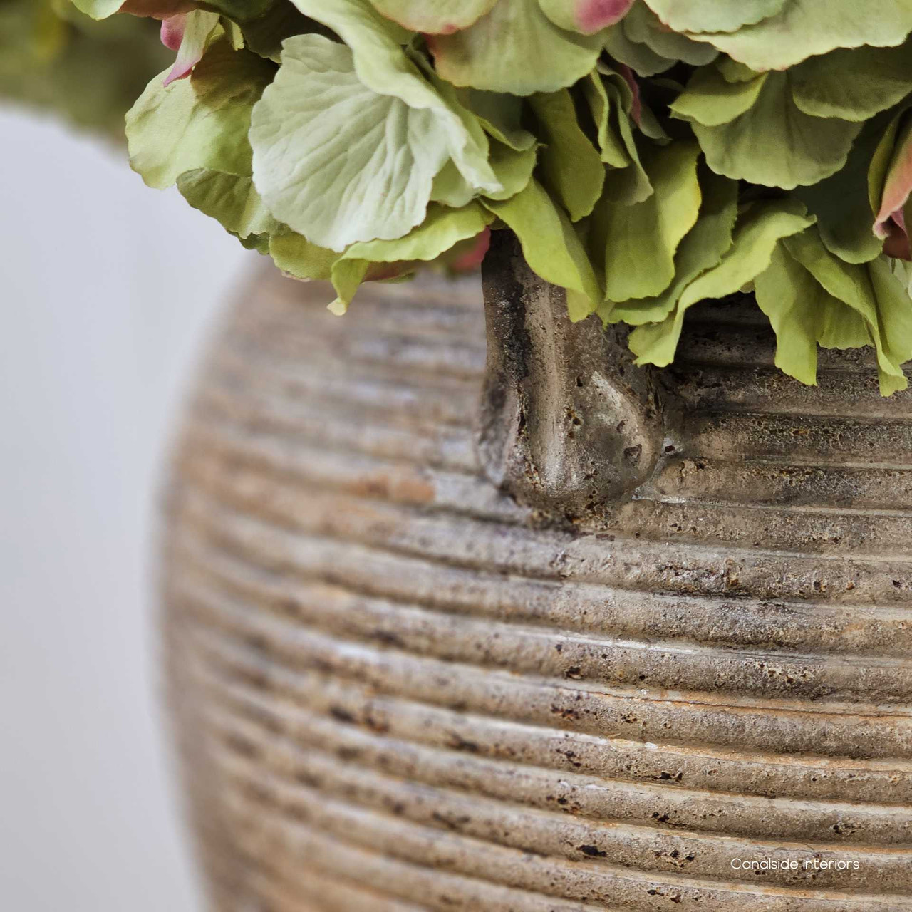 Close-up of weathered patina on the ribbing, revealing the handcrafted nature and subtle tonal shifts in the clay.