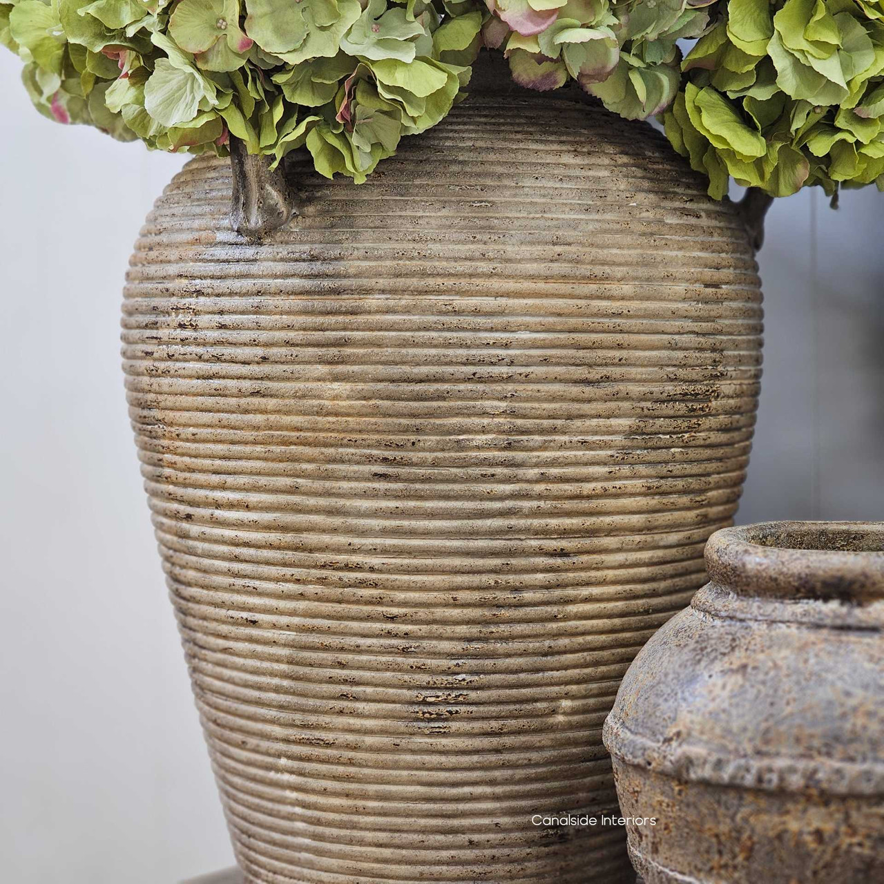 Decorative grouping with vintage textures and dried florals, showing the Lirien’s role in layered, grounded interiors.