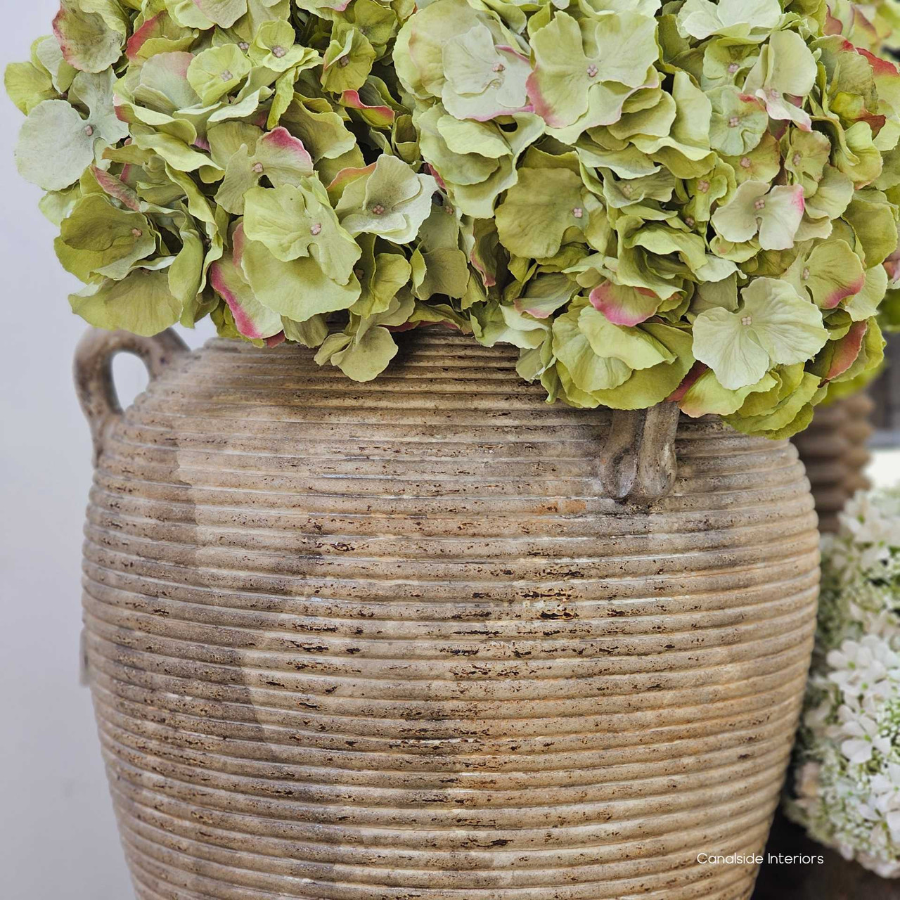 Side profile highlighting the pot’s tapered base and wide shoulders, emphasising its sculptural proportions and grounding silhouette.