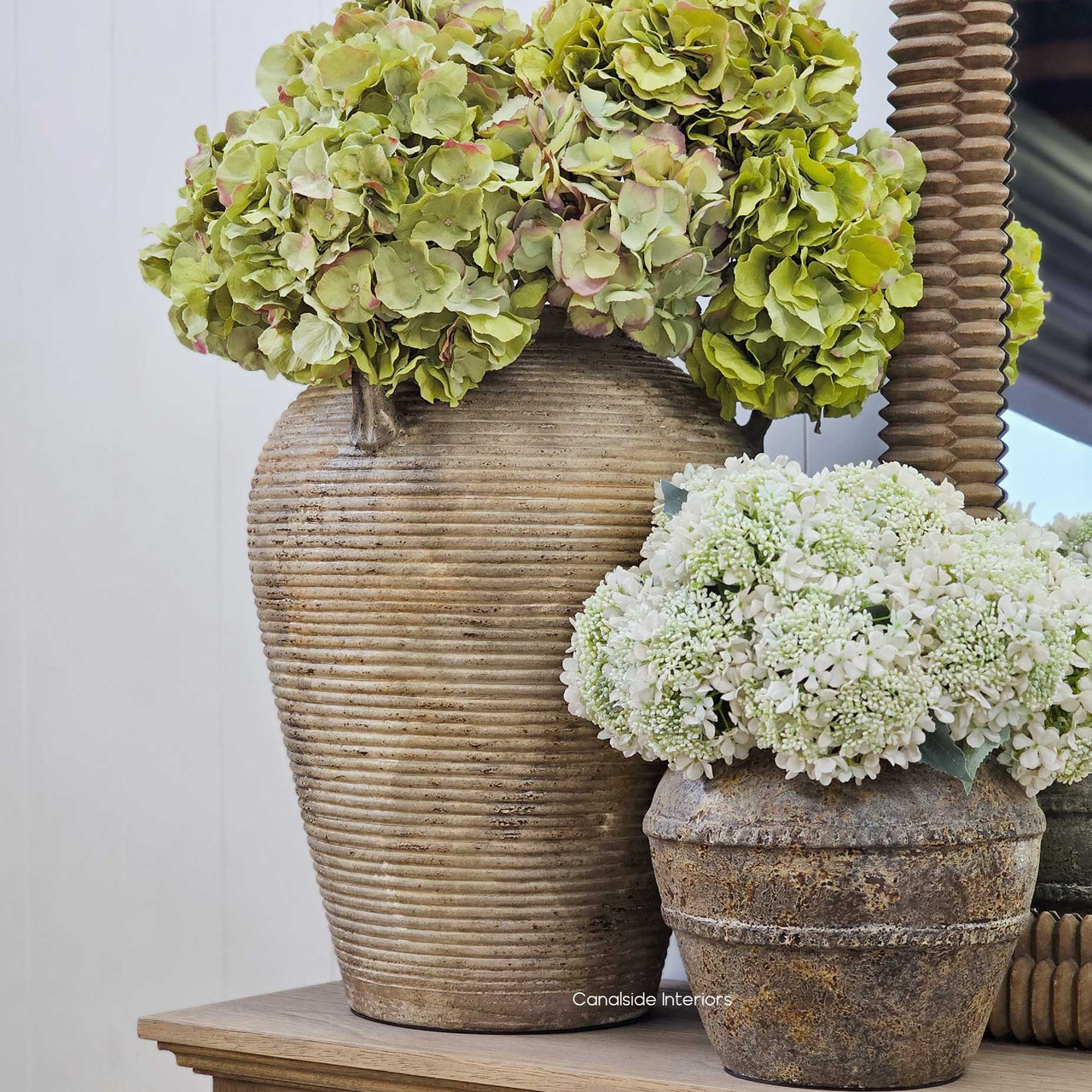 Full view of the Lirien Large Pot Terracotta Vessel styled with hydrangeas, showcasing its generous size and ribbed texture.