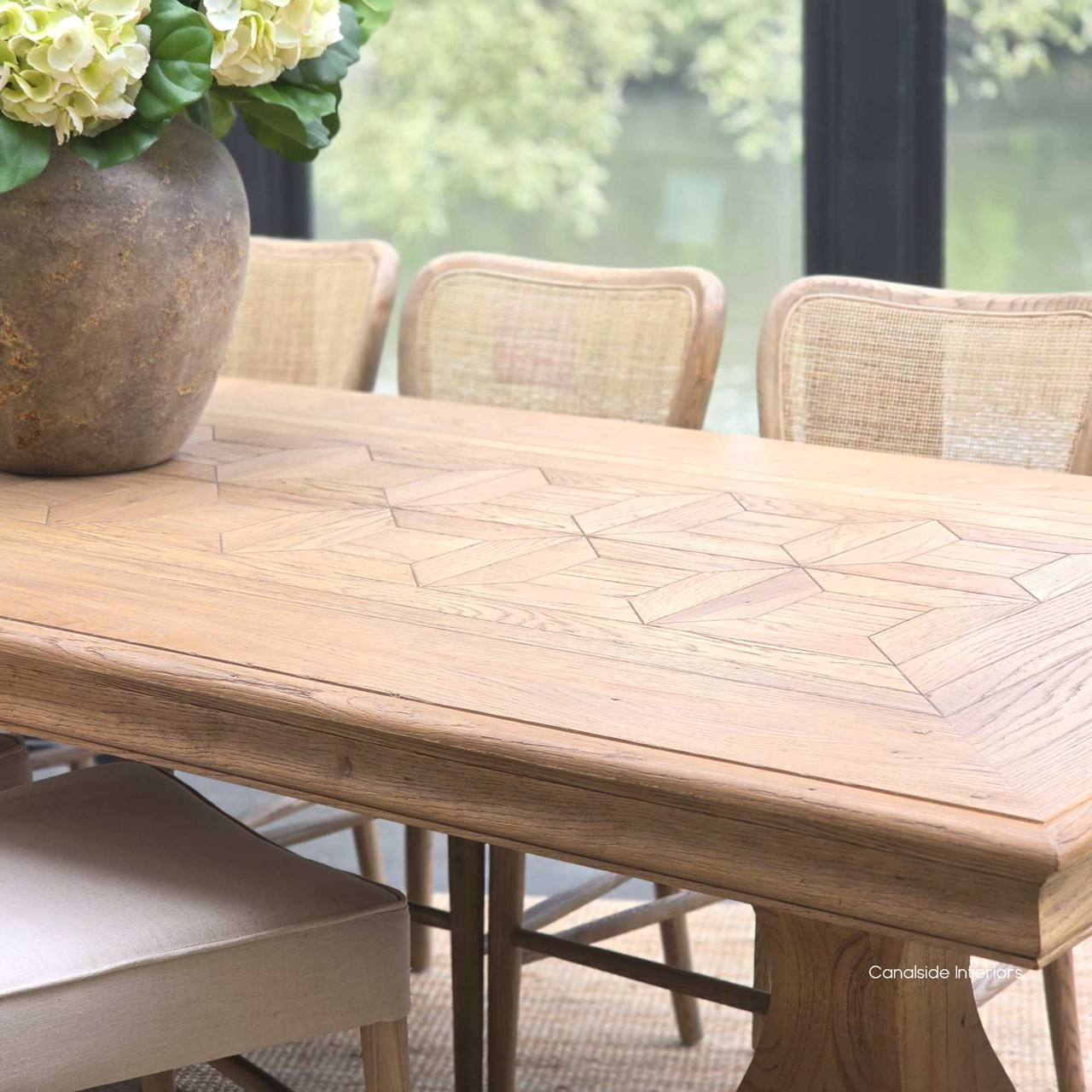 Close-up of the parquetry detail on the tabletop, revealing the quality of the timber grain.