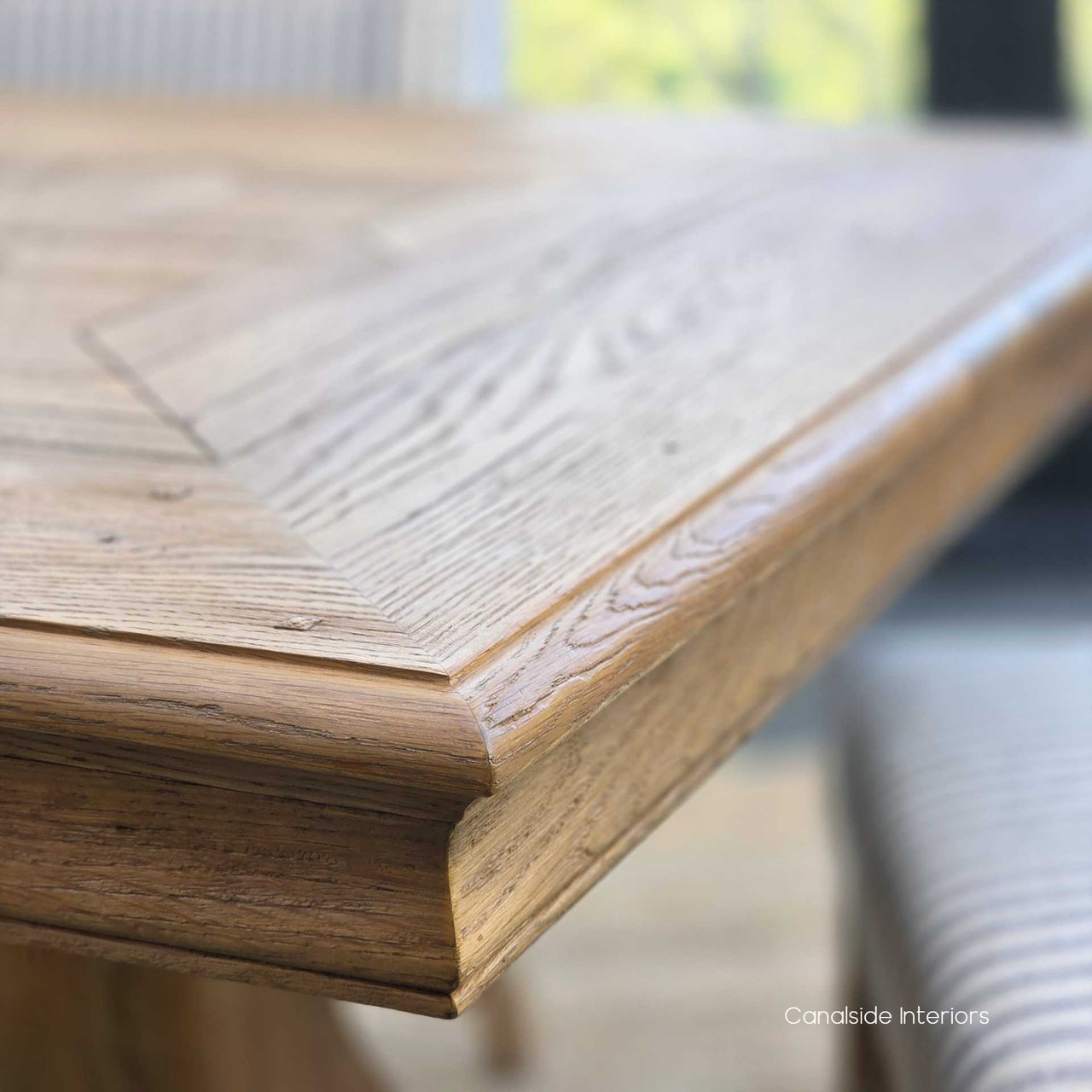 Corner close-up of the tabletop showing the intersecting parquetry pattern.