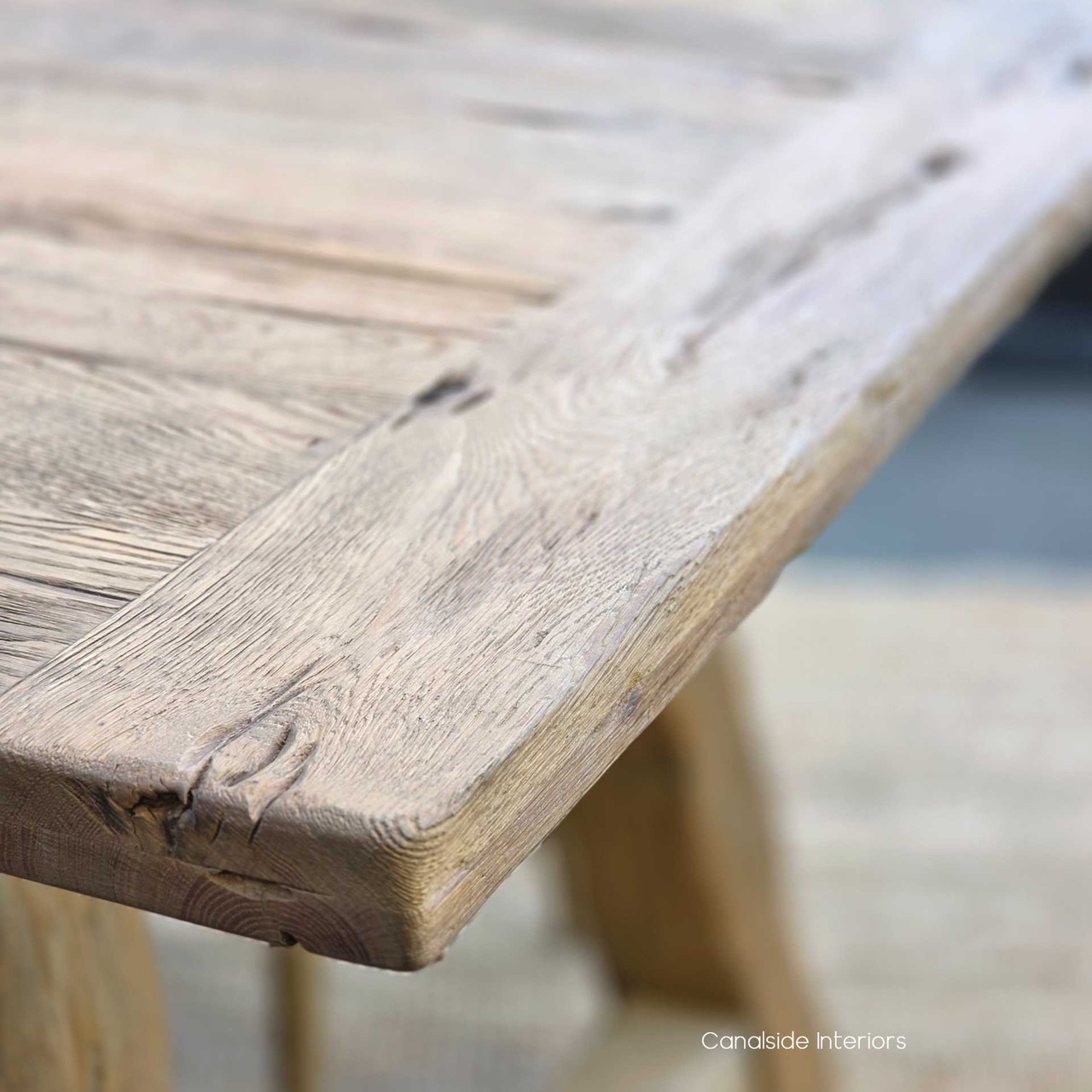 Close-up of the tabletop showing weathered grain and reclaimed timber character.