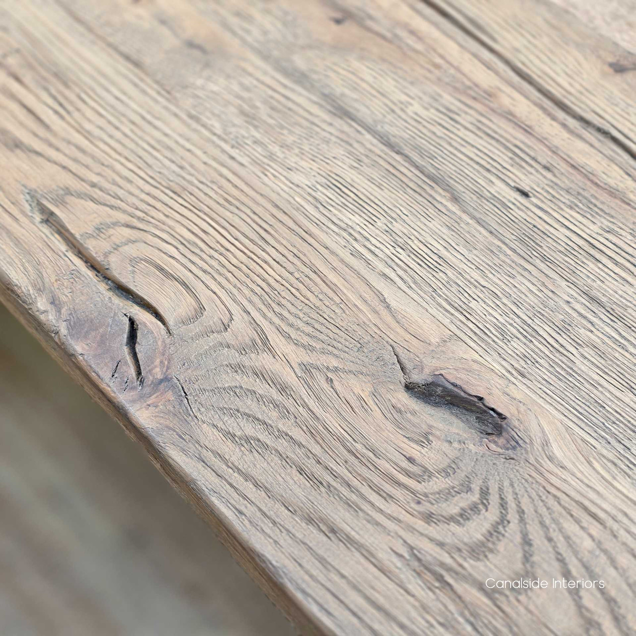 Close-up of a knot in the timber showing the raw, organic texture of reclaimed wood.