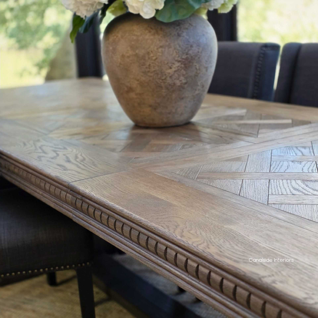 Close-up of the Cigar oak parquetry tabletop with hand-laid pattern and border inlays.