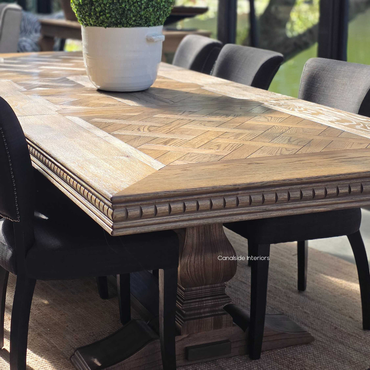 Hand-crafted from genuine oak, the Berenson features a striking parquetry top and double extension leaves, finished in a rich Cigar patina.