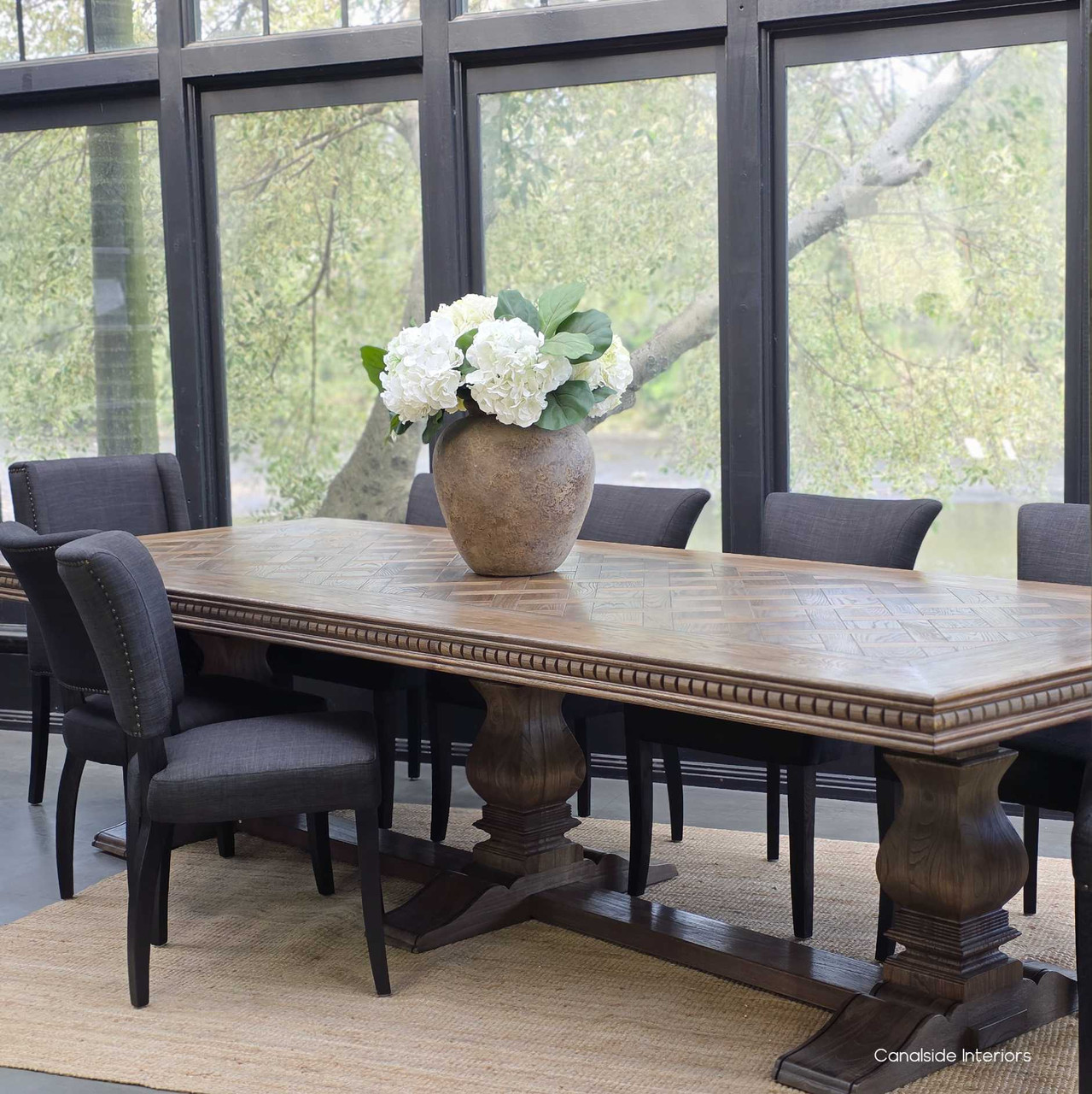 Cigar oak parquetry dining table ready for a dinner party.