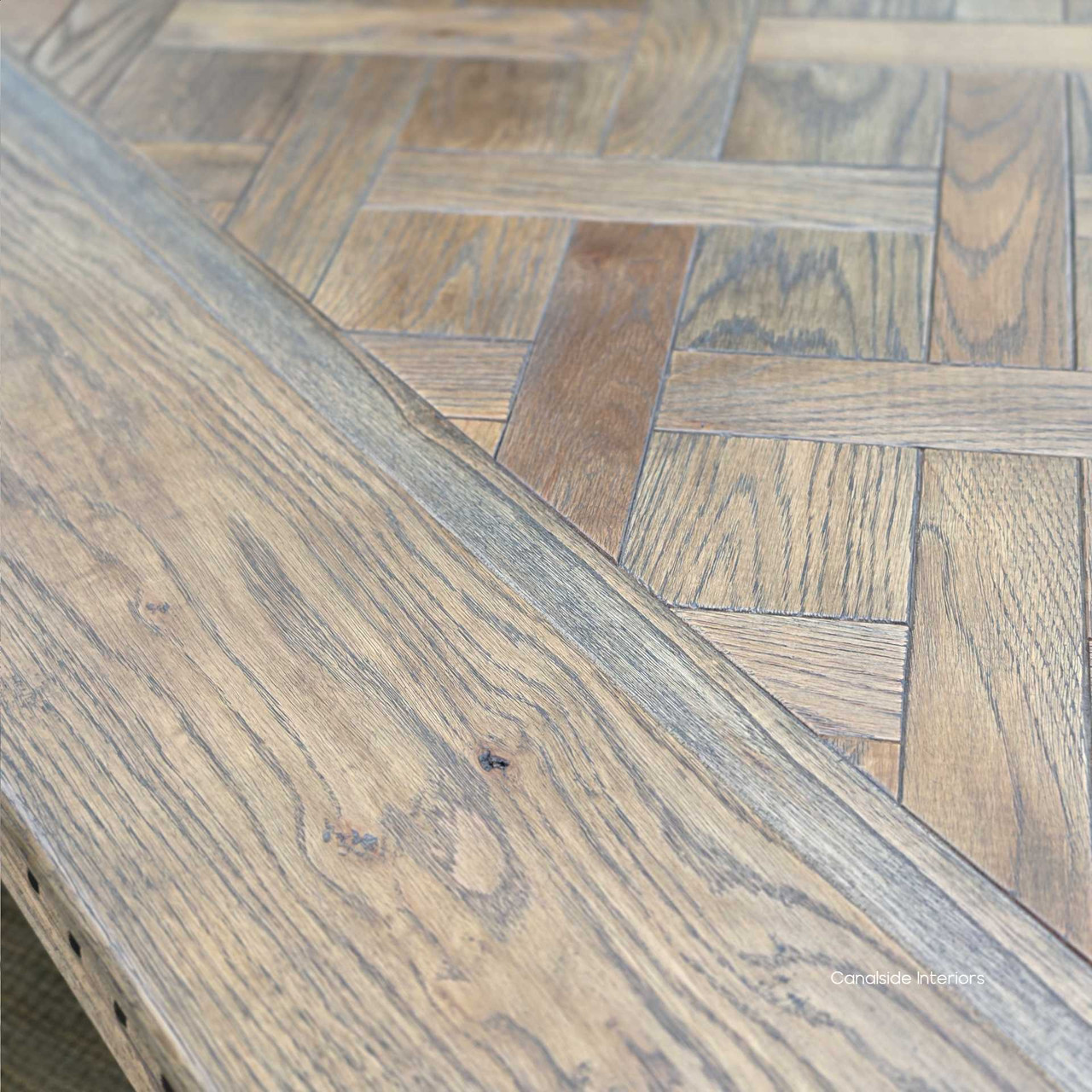 Grain detail on Cigar oak parquetry table captured in natural daylight.
