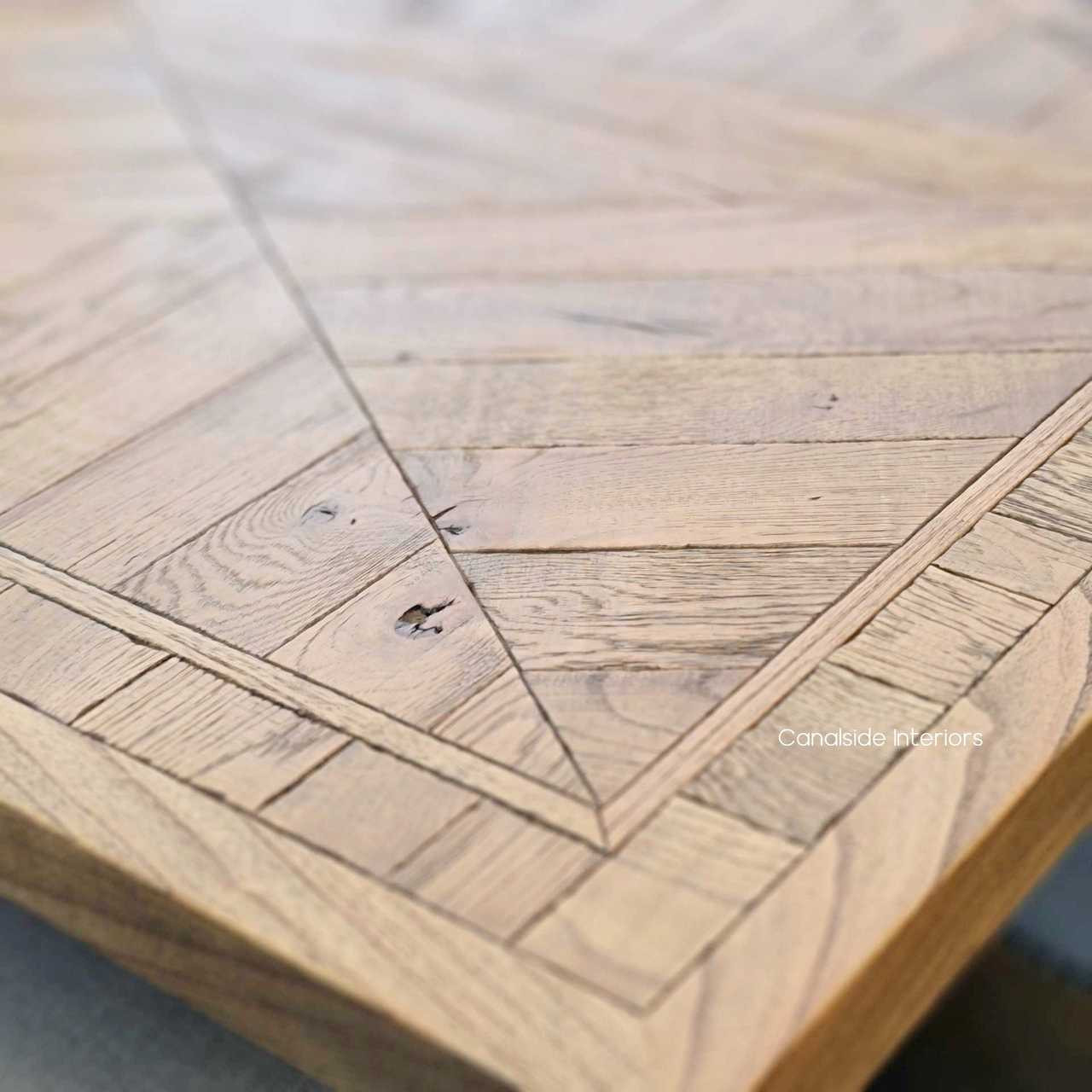 The Danbury Oak Dining Table: a blend of strength and beauty, with its robust oak construction and exquisite parquetry, ideal for creating memorable dining spaces - Canalside Interiors
