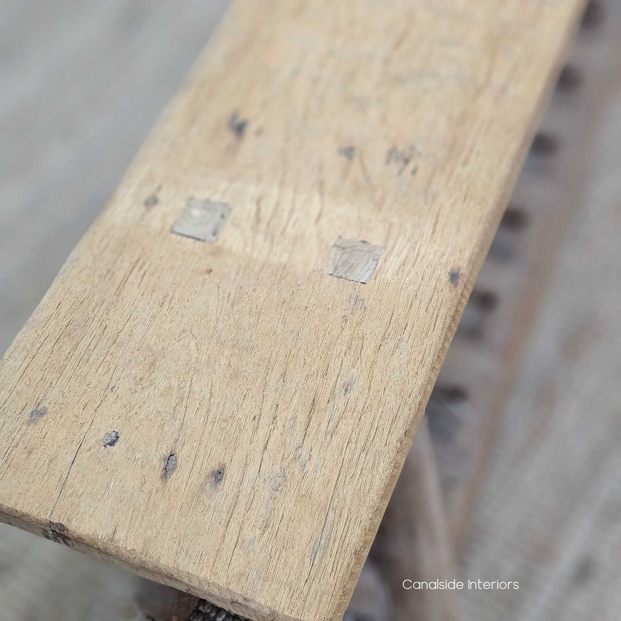 Top-down view of the Vintage Teak Bench, revealing its organic texture, rich teak finish, and spacious slatted base.