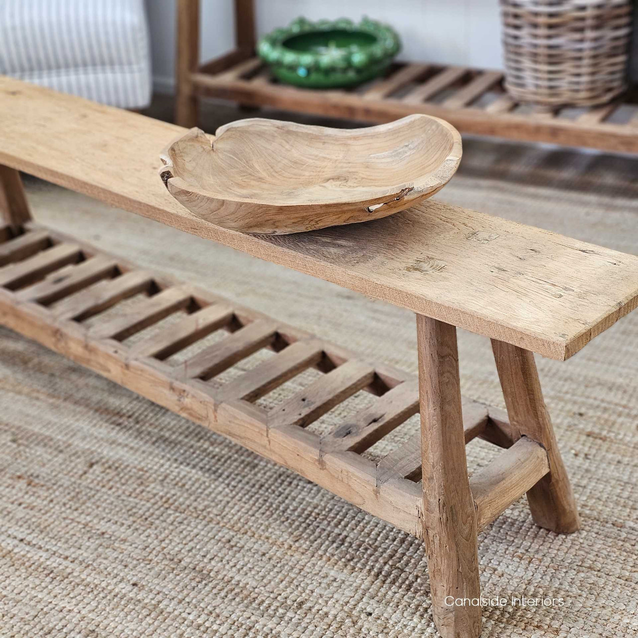 Side angle of the Vintage Teak Bench, highlighting its slatted lower shelf and beautifully weathered patina.