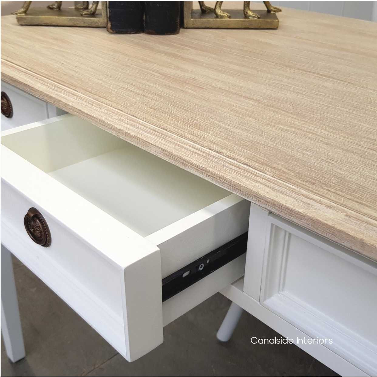 View of the desk/console's limewash top, ideal for displaying decorative items or writing upon, the intricate handle design, marrying functionality with aesthetic beauty in every detail.