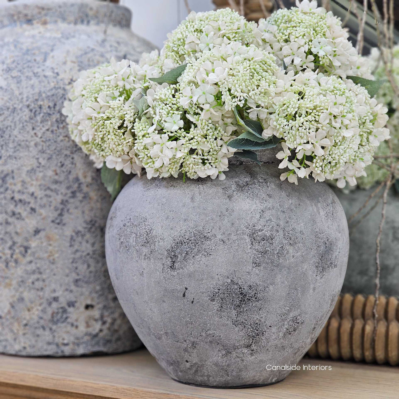 Angled view of the Tala Pot Vessel in smooth rustic stone stylewash showcasing its rounded silhouette and soft mineral tones.