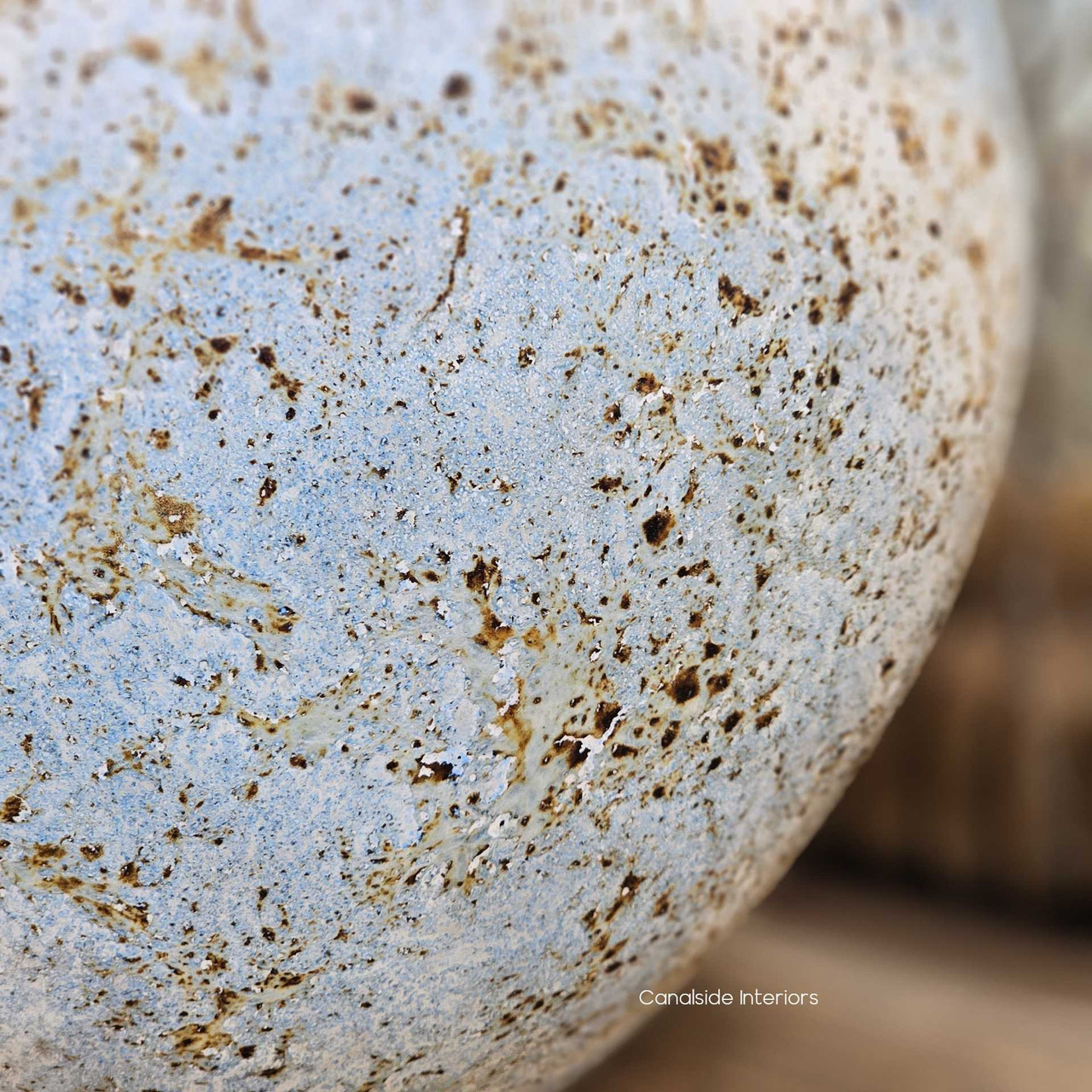 Texture close up revealing delicate speckling across the vessel’s surface.