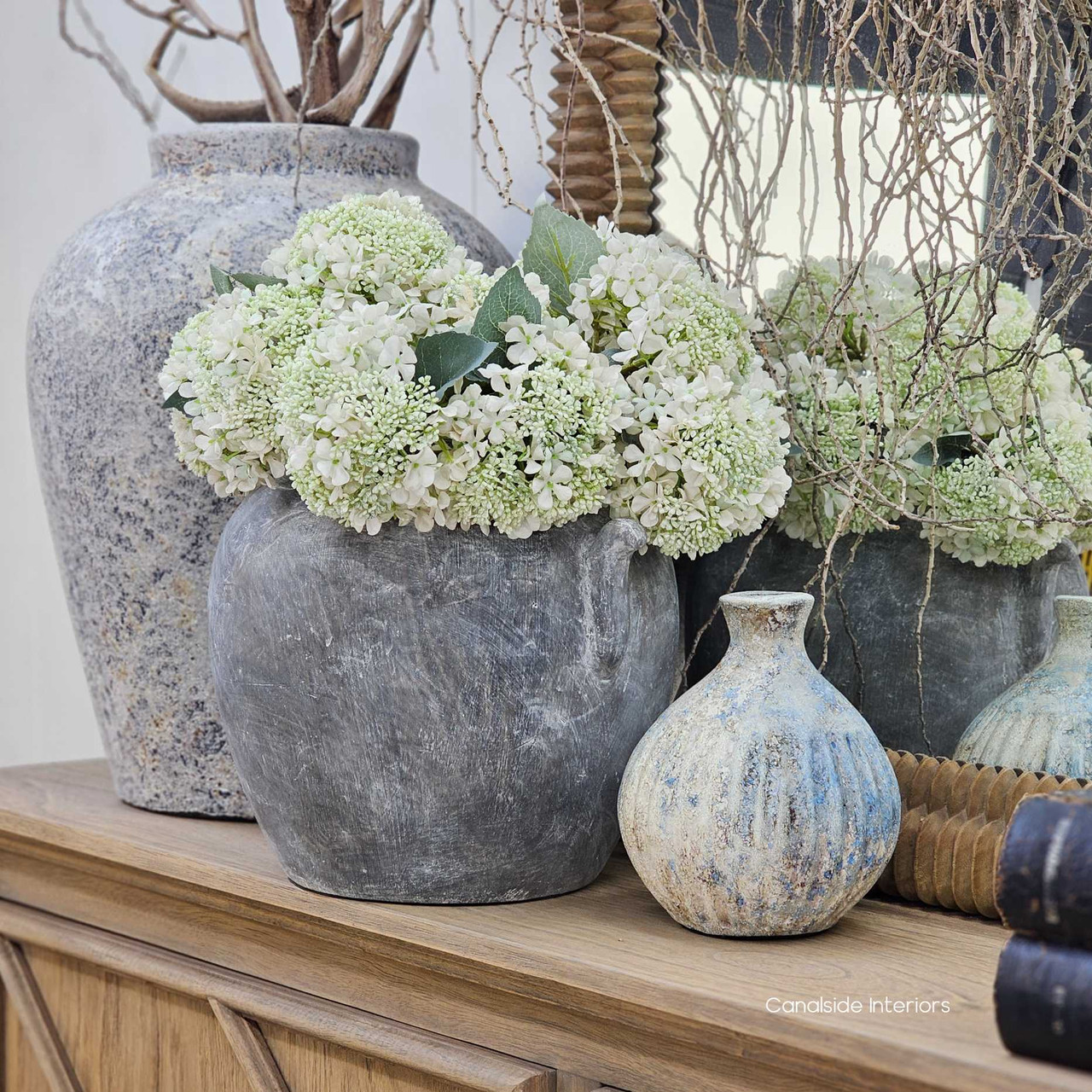 Group shot showing the Angin Vessel paired with other textured clay pots.