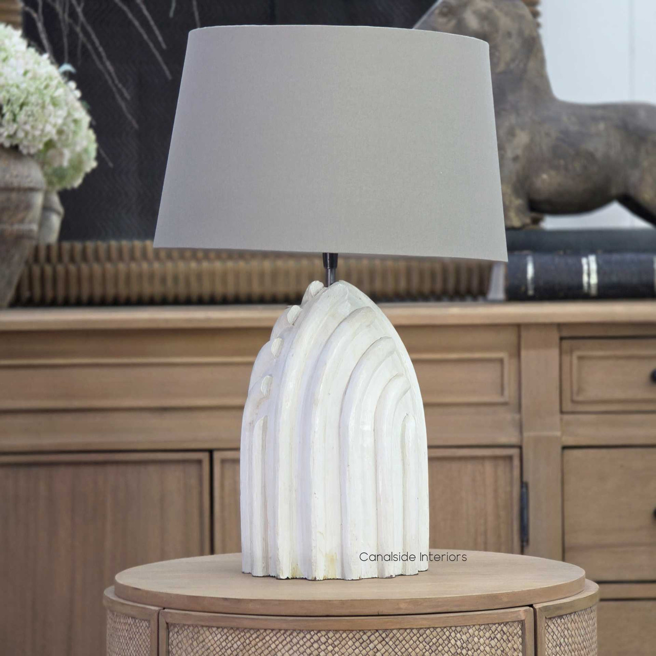 Margaux table lamp in distressed off-white with taupe shade on side table