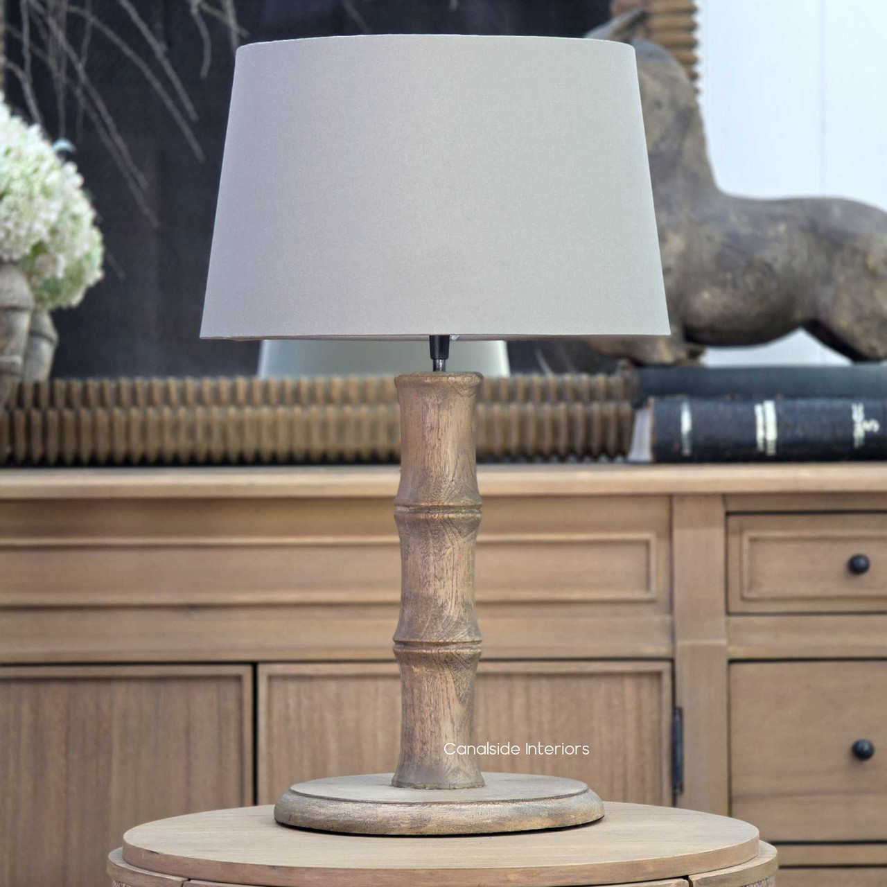 Chippendale bamboo style lamp with taupe shade on side table