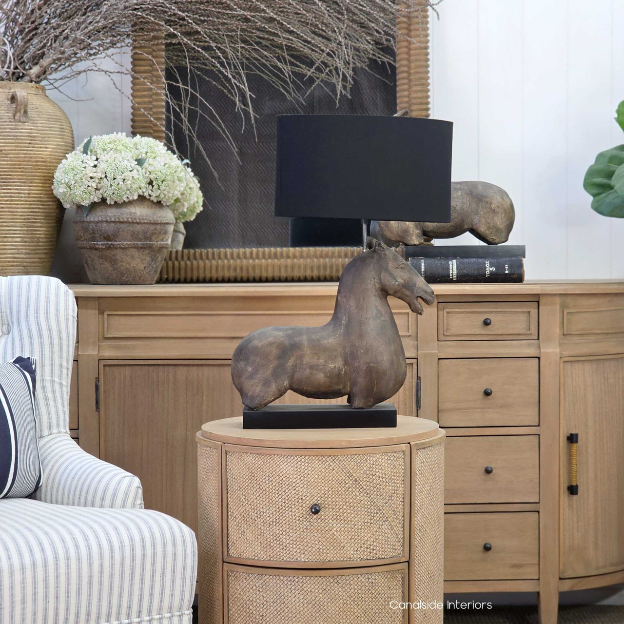 Single horse table lamp with black shade in coastal interior