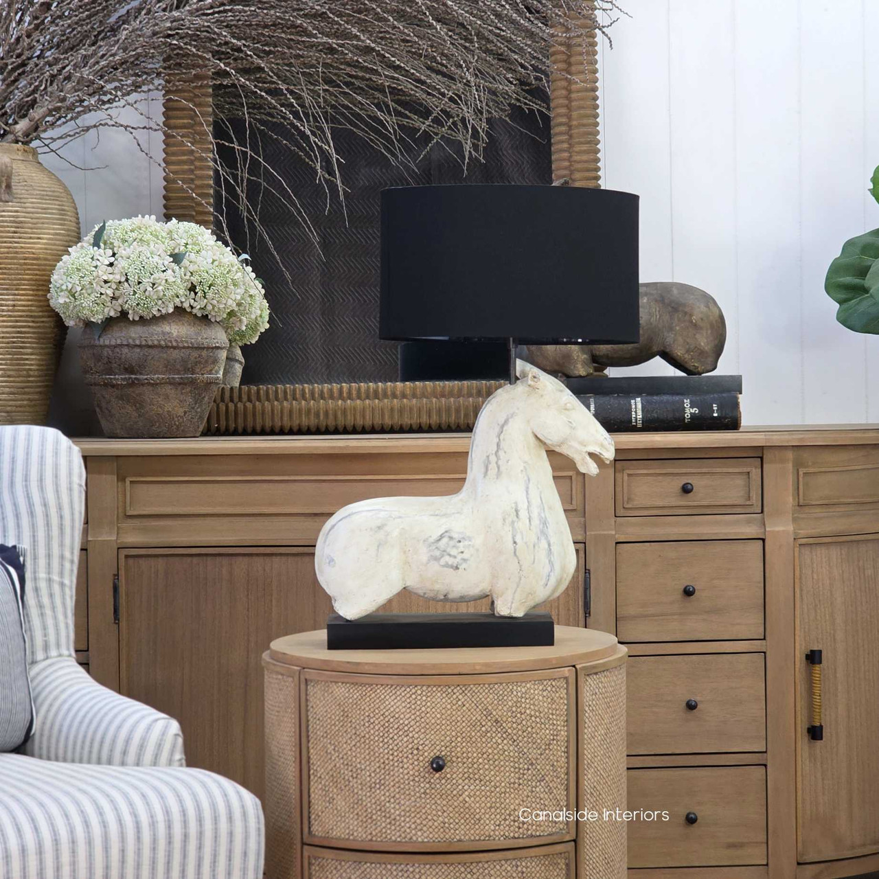 Single horse table lamp with black shade in coastal interior