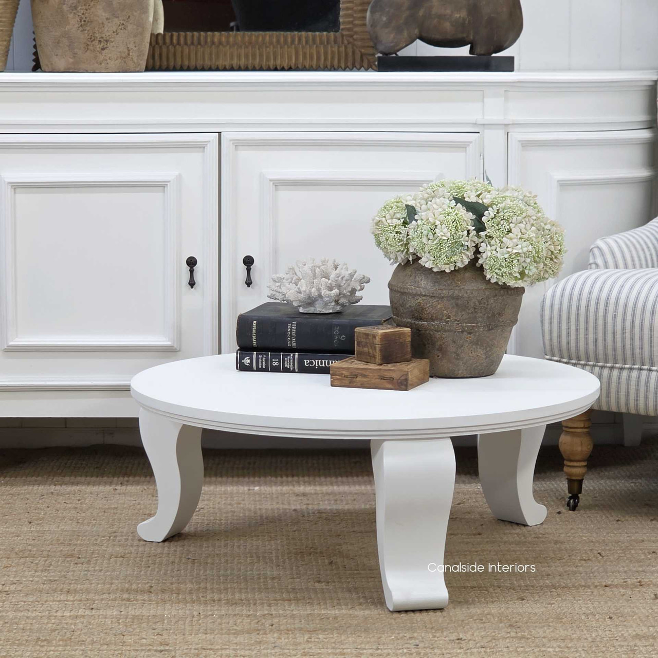 Genevra Coffee Table styled with floral arrangement and decorative accents for a refined interior look.