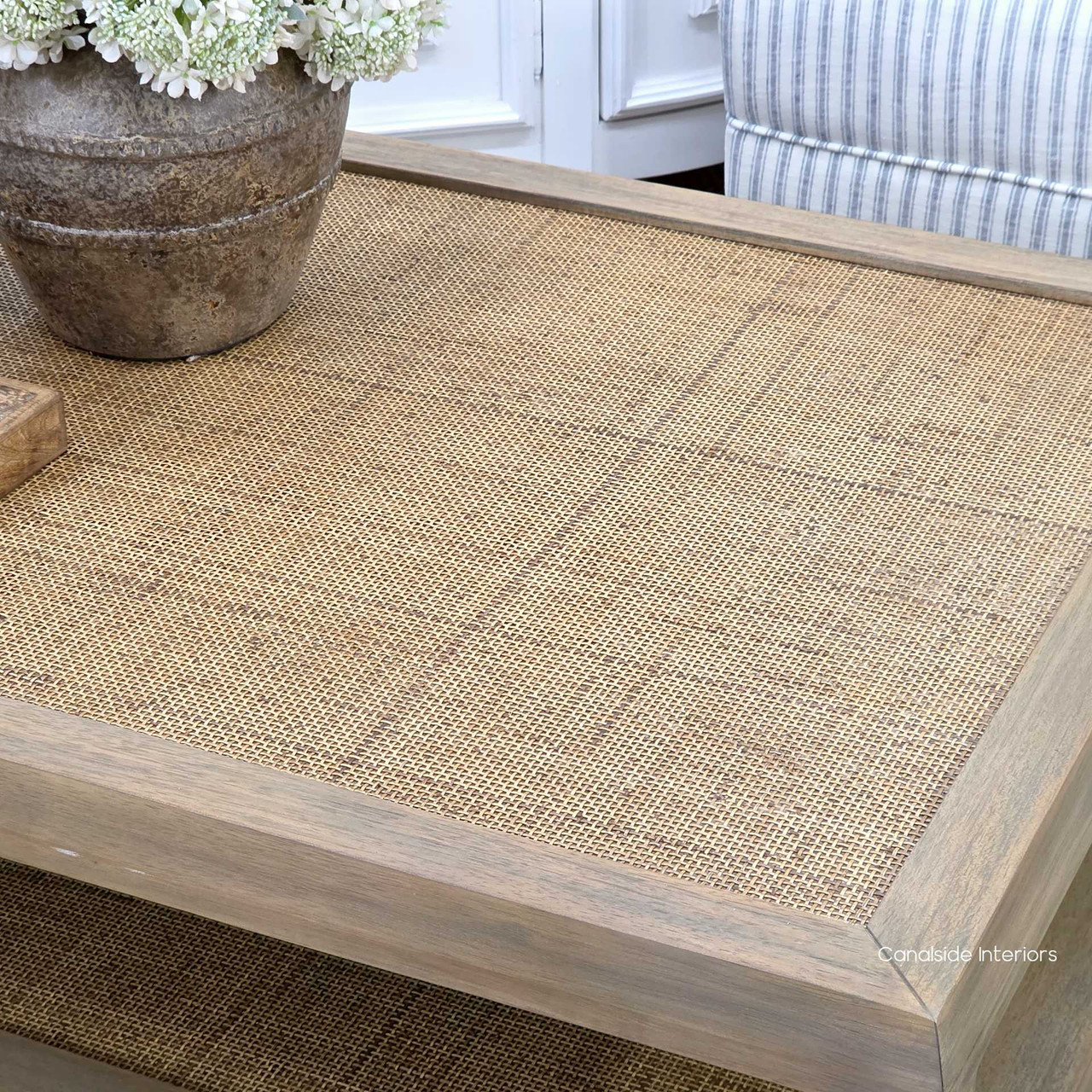 Close-up of woven rattan tabletop detail on the Haddon Rattan Coffee Table showing natural texture and craftsmanship