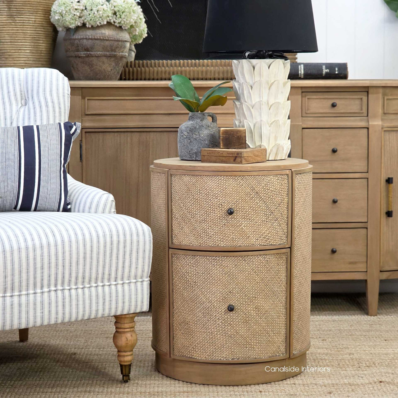 Front view of the Langston Rattan Side Table showcasing its modern silhouette and deep, earthy tones.