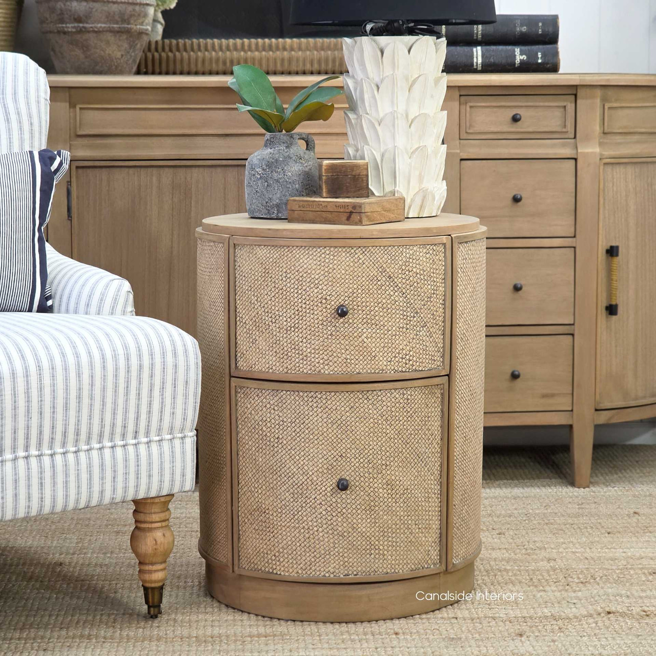 front view of the Langston Rattan Side Table, showcasing its modern silhouette and deep, earthy tones.