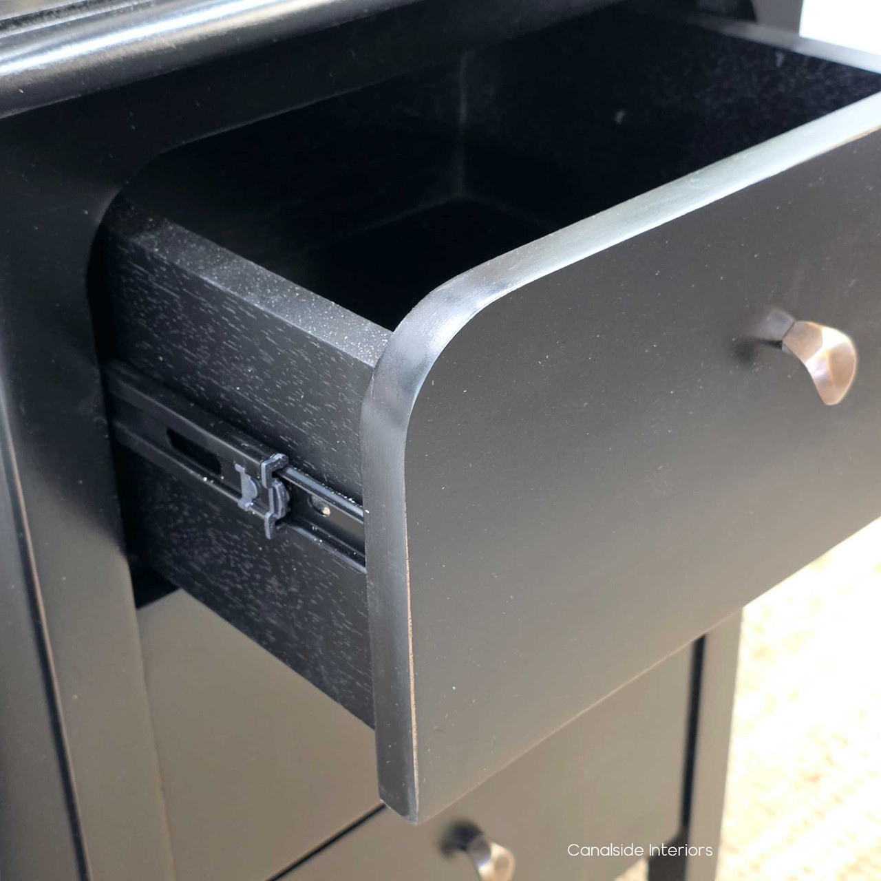 Open drawer view of the Creemore 3 Drawer Bedside in Black with smooth metal runners for easy everyday use