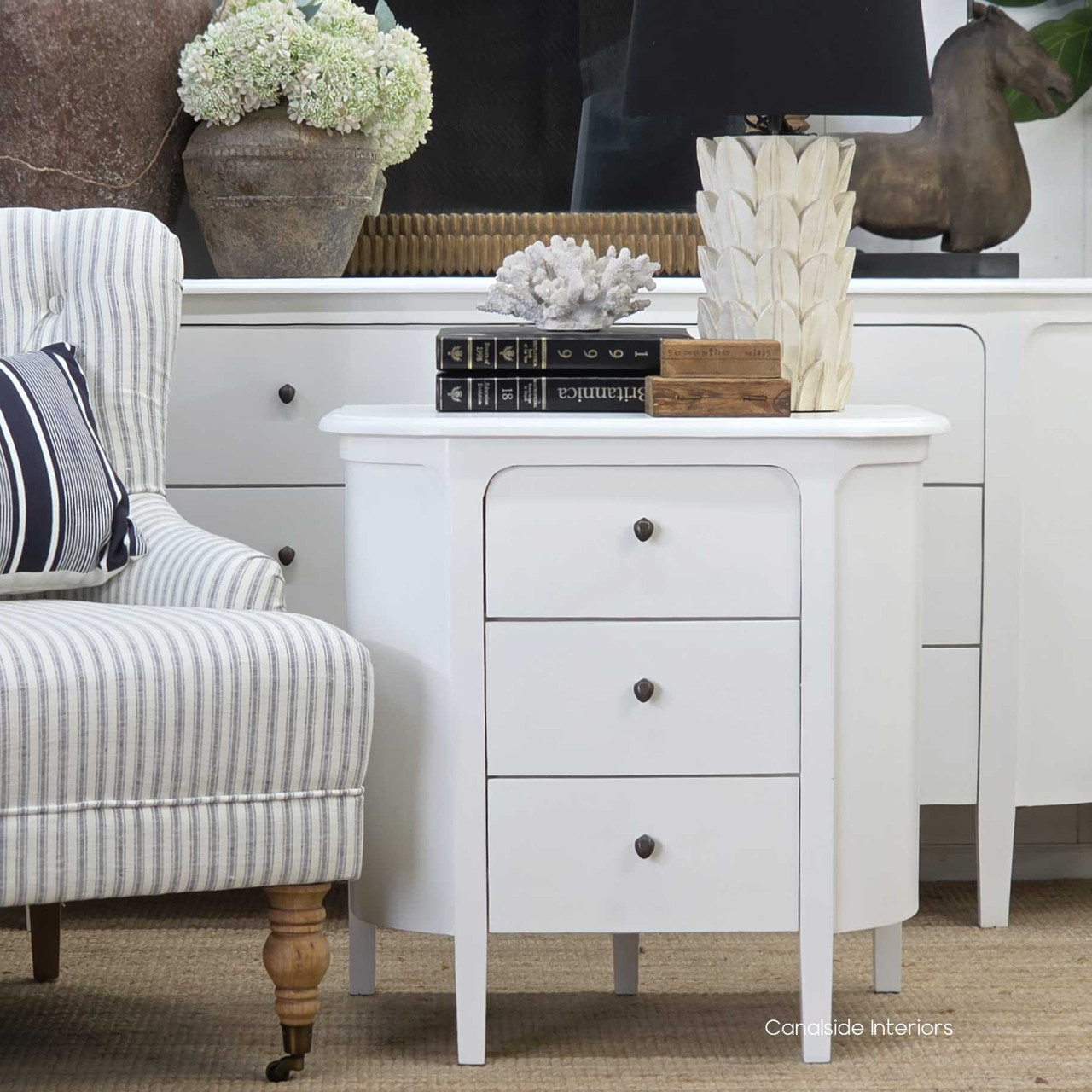 Front view of the Creemore 3 Drawer Bedside in White, showcasing its curved silhouette, painted finish and simple round hardware
